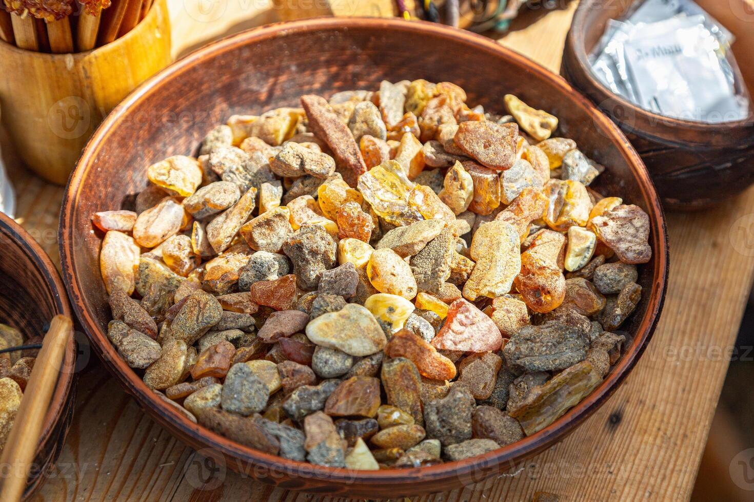 A detailed close-up of assorted polished and unpolished amber stones, showcasing their rich colors and textures. photo