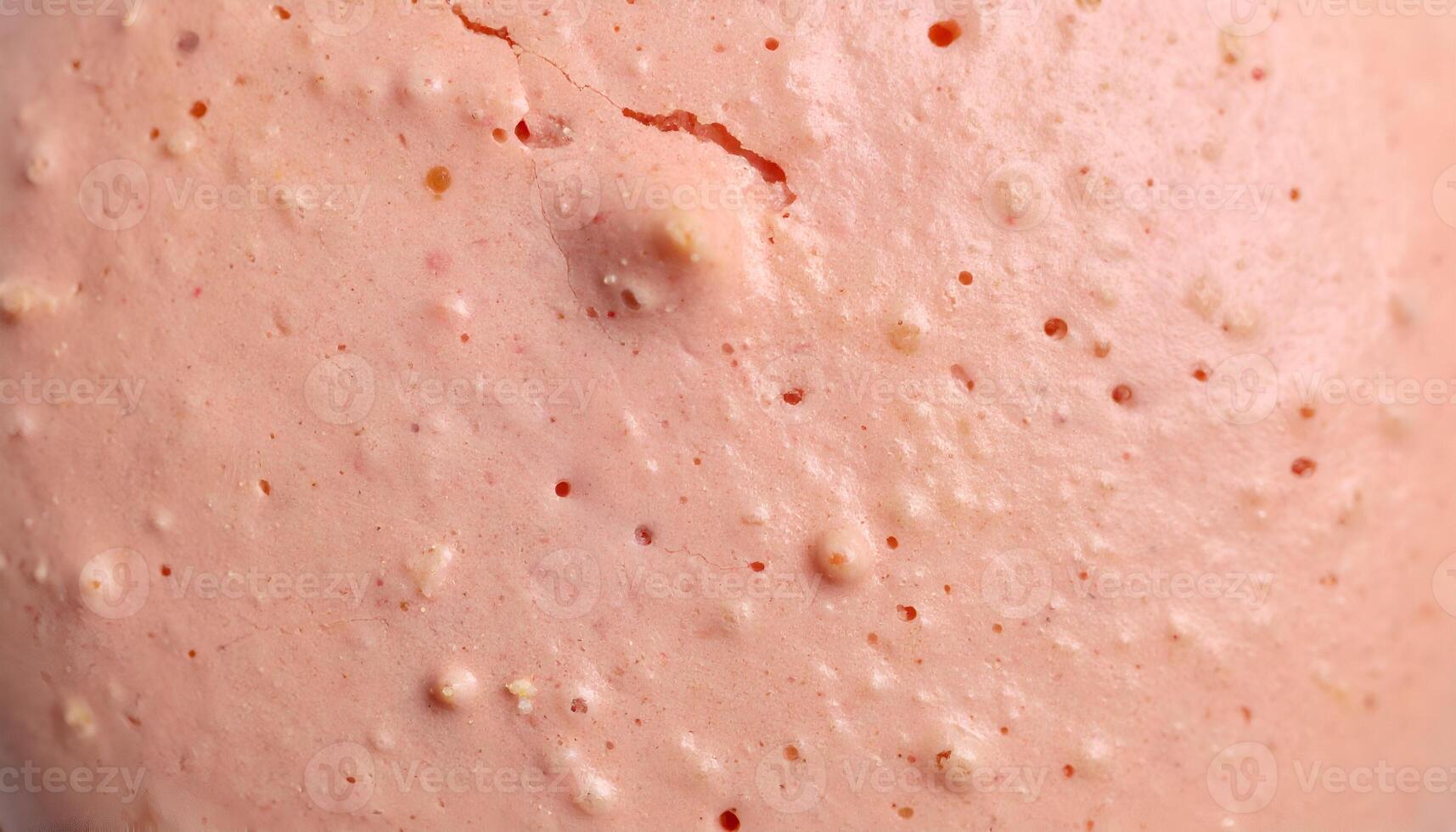 close-up macro texture of pink macaron shell surface with bumps and air holes, pastel bakery background, smooth and cracked baked crust photo