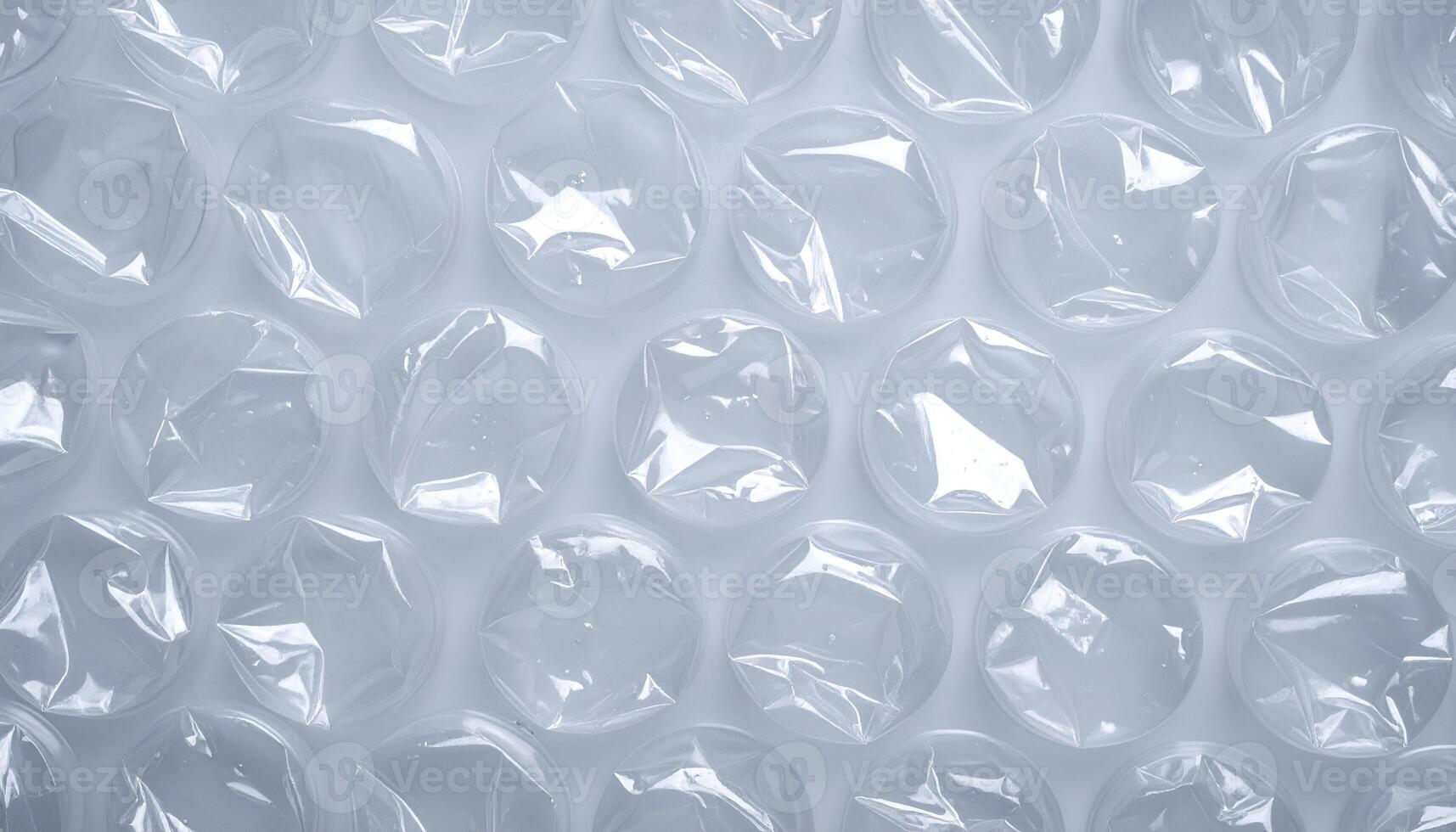top view of transparent plastic bubble wrap texture with circular air pockets in soft lighting for packaging background photo