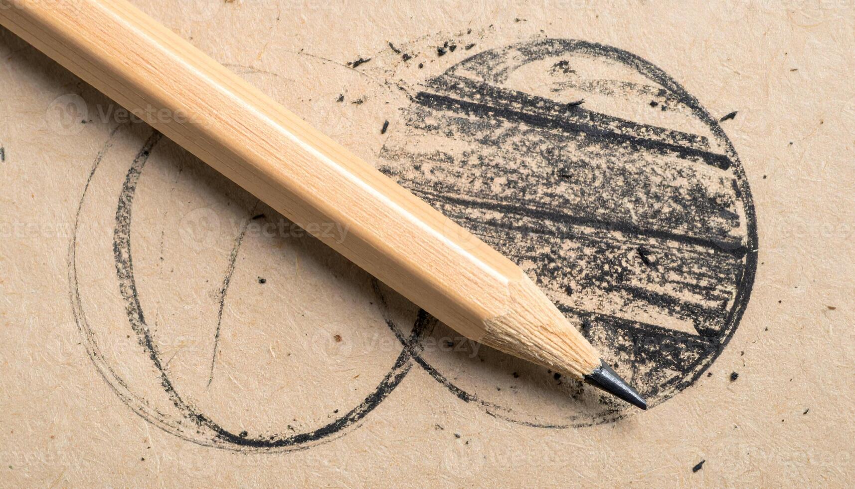 macro close-up of graphite pencil drawing and eraser marks on rough recycled paper with hand-drawn sketch texture and wooden pencil tip photo