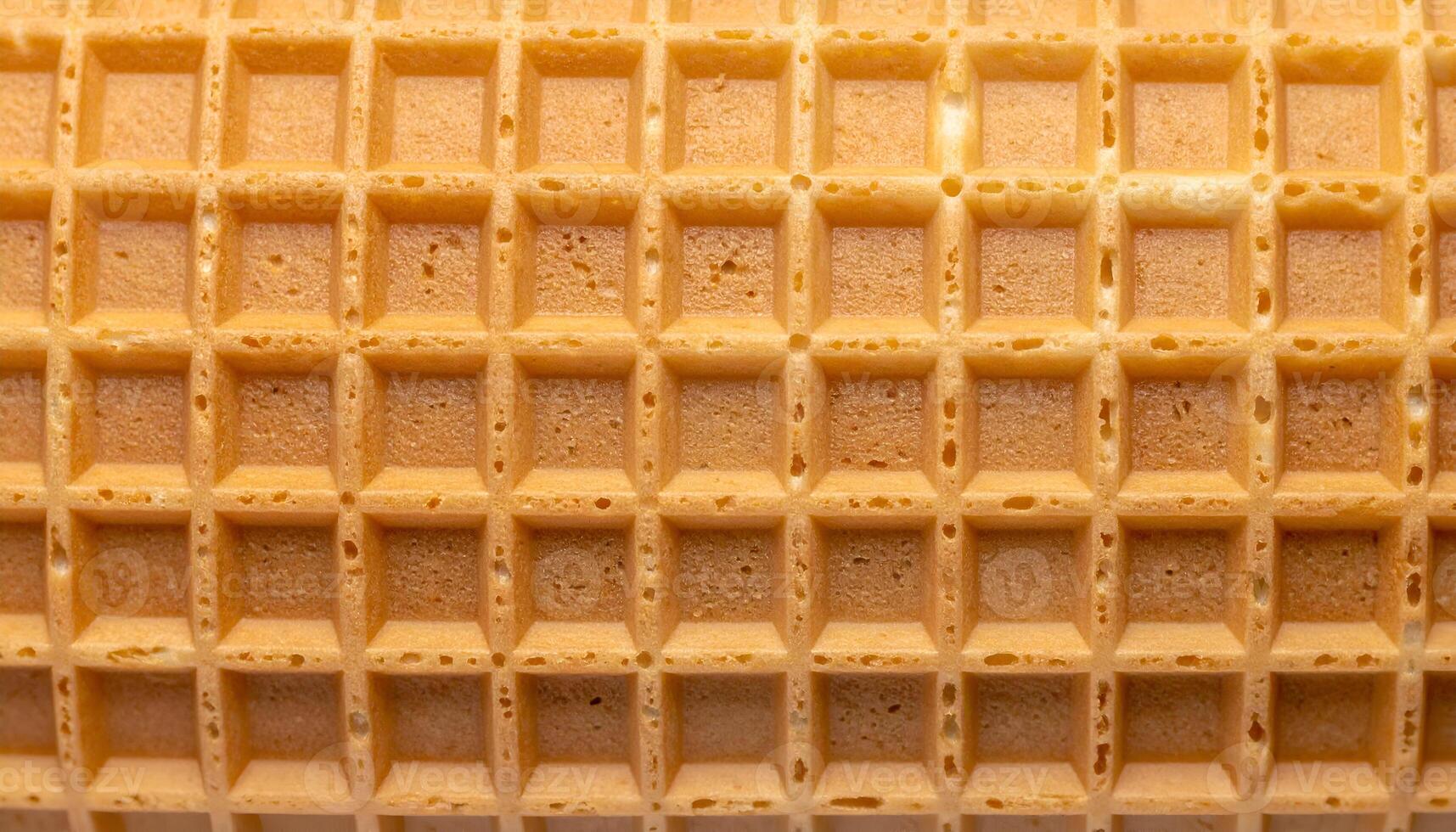 ultra detailed waffle cone texture with square grid pattern, top view macro of crispy baked dessert surface for food packaging or background photo