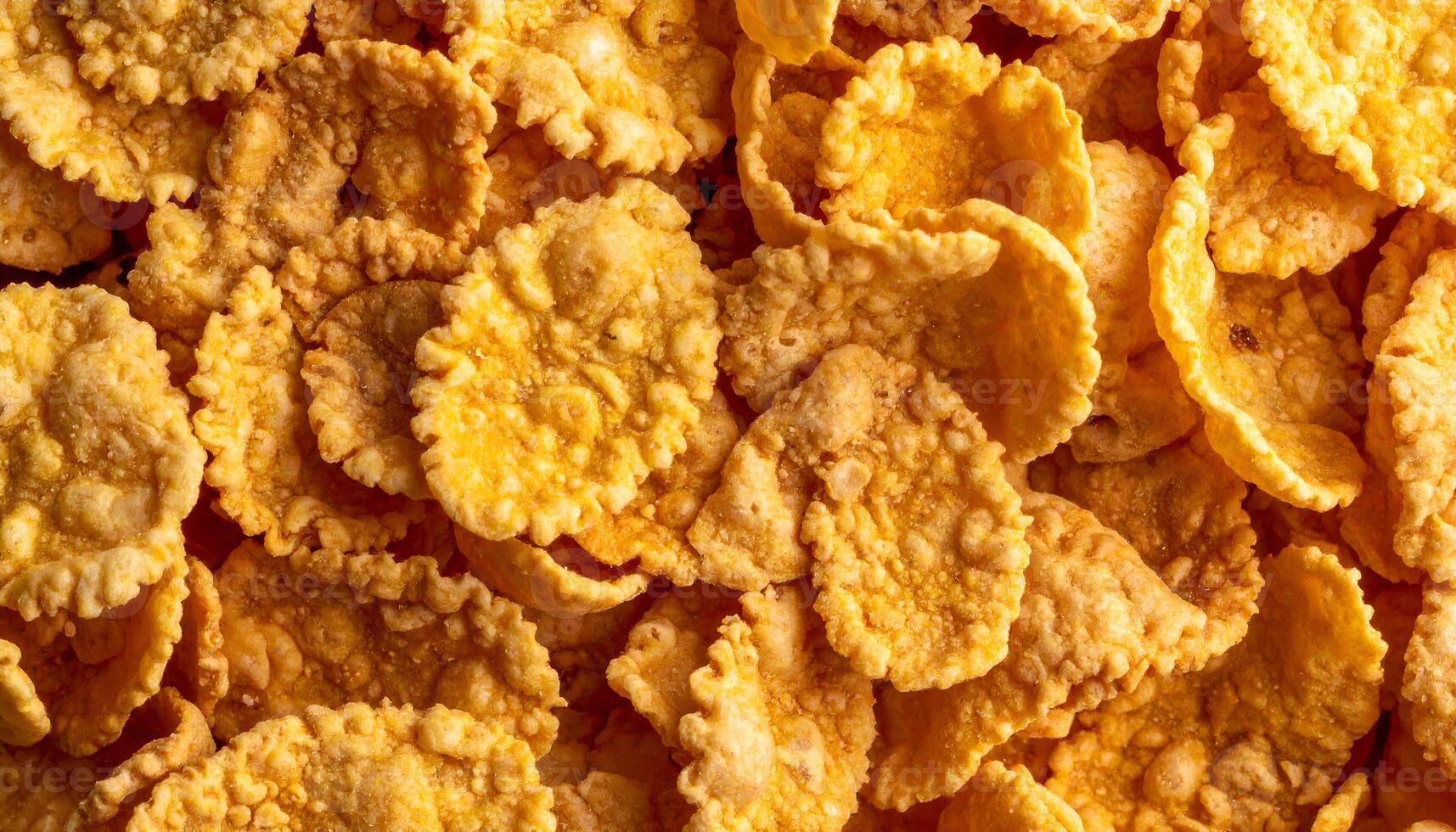 macro close-up of crispy cereal flakes with golden texture and rough surface, crunchy breakfast food detail for packaging, nutrition and healthy eating design photo