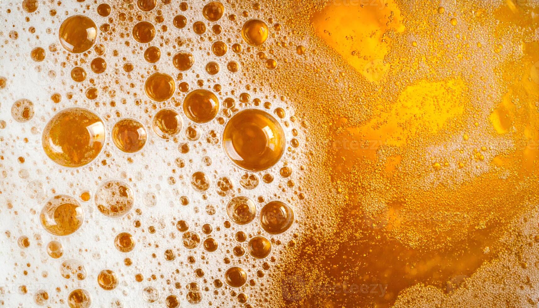 macro texture of beer foam with golden bubbles and frothy surface, abstract beverage background for party and alcohol themes photo