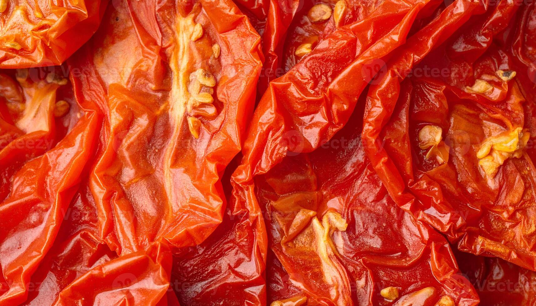 macro close-up of sun-dried tomato halves with wrinkled skin and seeds, detailed texture of dehydrated vegetable for food background or healthy cooking photo