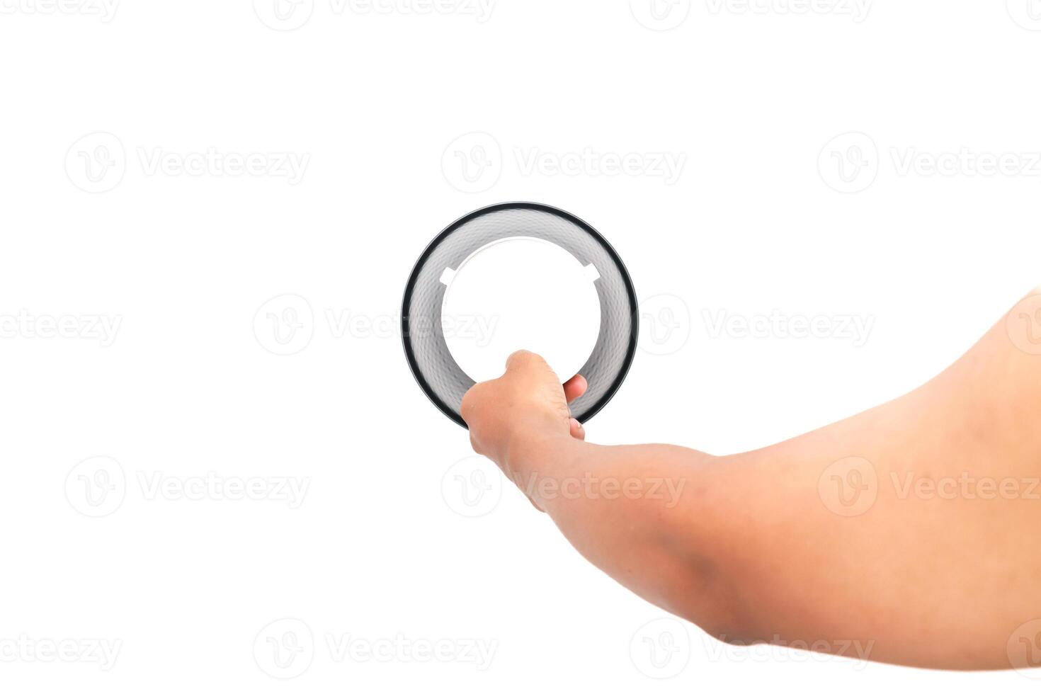Hand holding circular object against white background for product presentation or demonstration photo