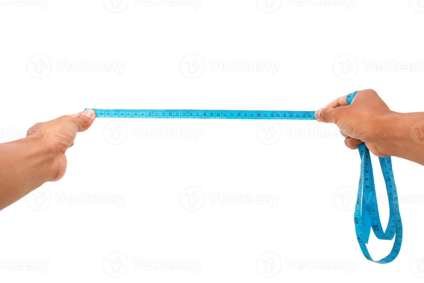 Hands stretching a blue measuring tape, isolated on white background studio shot photo