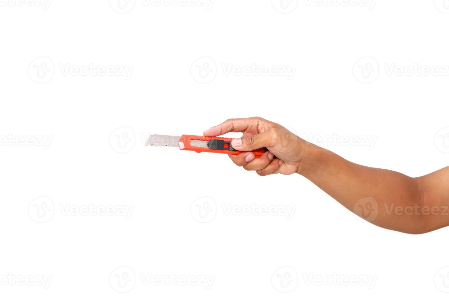 Hand holding a box cutter, isolated on white, displaying tool use and dexterity photo