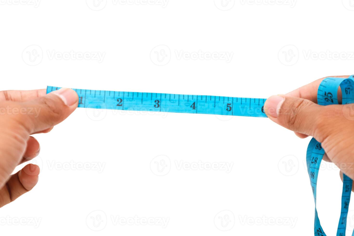 Hands holding a blue measuring tape, demonstrating precision measurement in garment creation photo