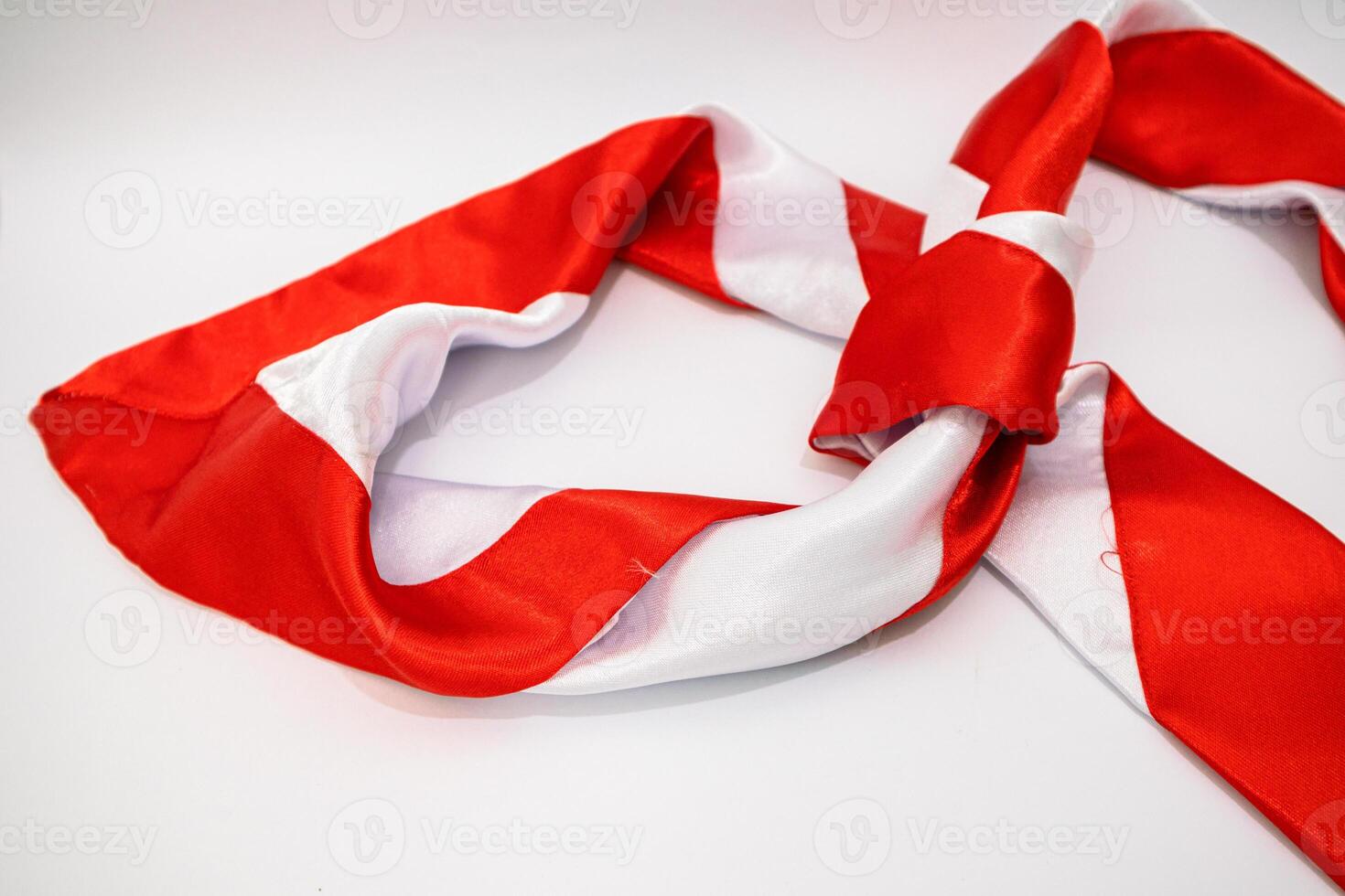 Red and White Striped Scarf on a White Background, Elegant and Fashionable photo