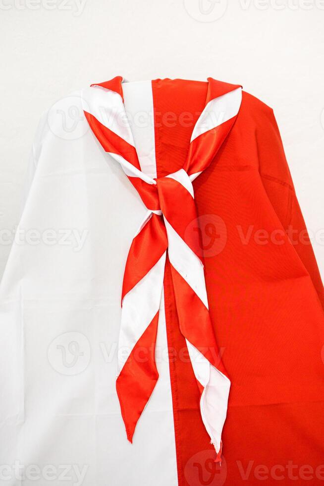 Red and white scarf draped over a white and red background showcases a vibrant contrasting design suitable for various creative projects photo