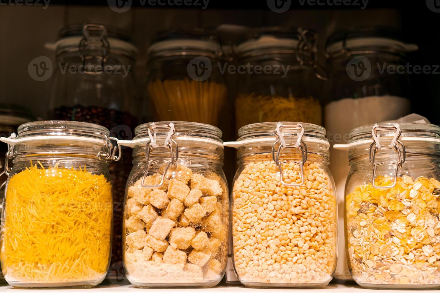 banner stand in a row of glass jars on a shelf with bulk products, the concept of organizing a kitchen space photo