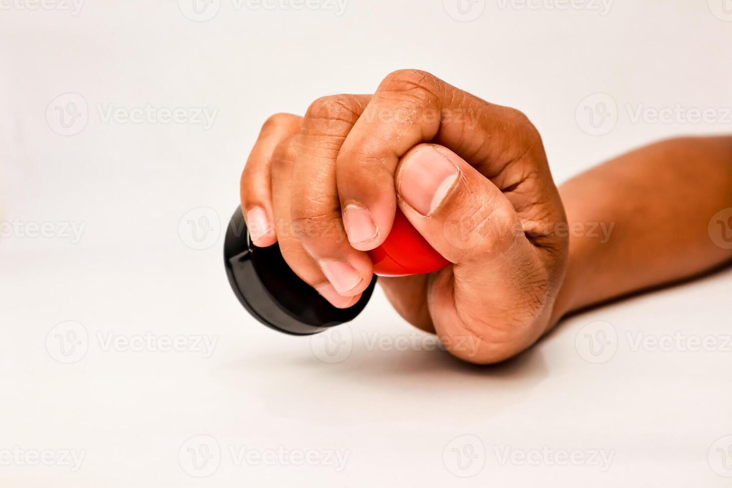 A hand holding a black and red rubber stamp ready to apply to a document or form for approval photo