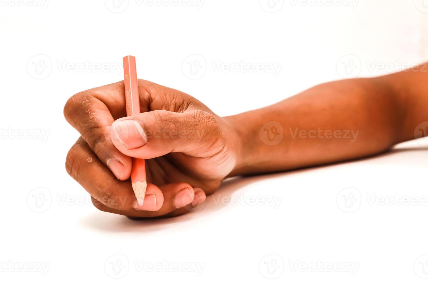 Hand gripping a pencil, ready to sketch on a white surface, focus on fingertips and arm photo