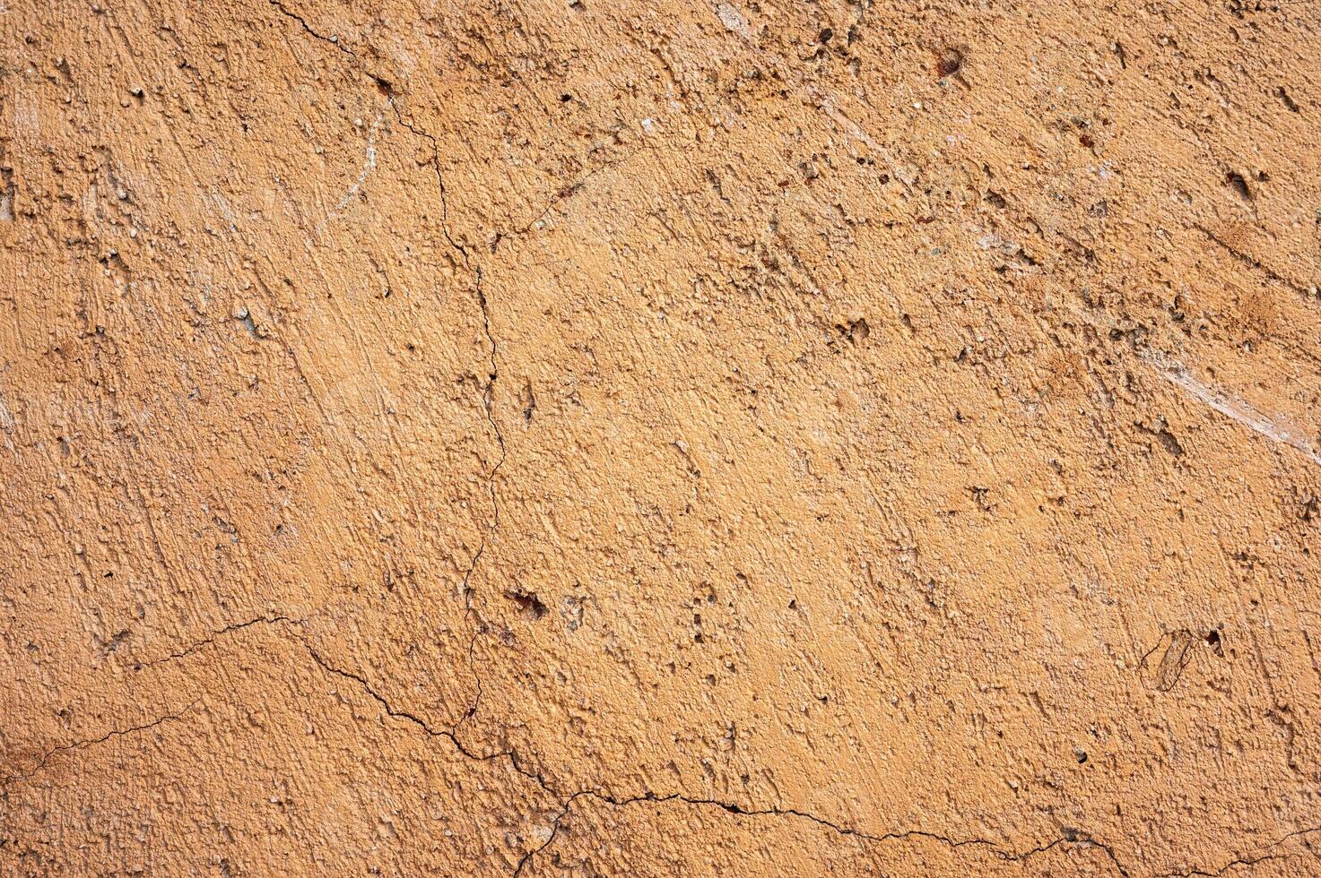 Earthen wall texture of clay house structure. These walls are constructed by ramming a mixture of aggregates, including gravel, sand, silt and a small amount of clay. photo