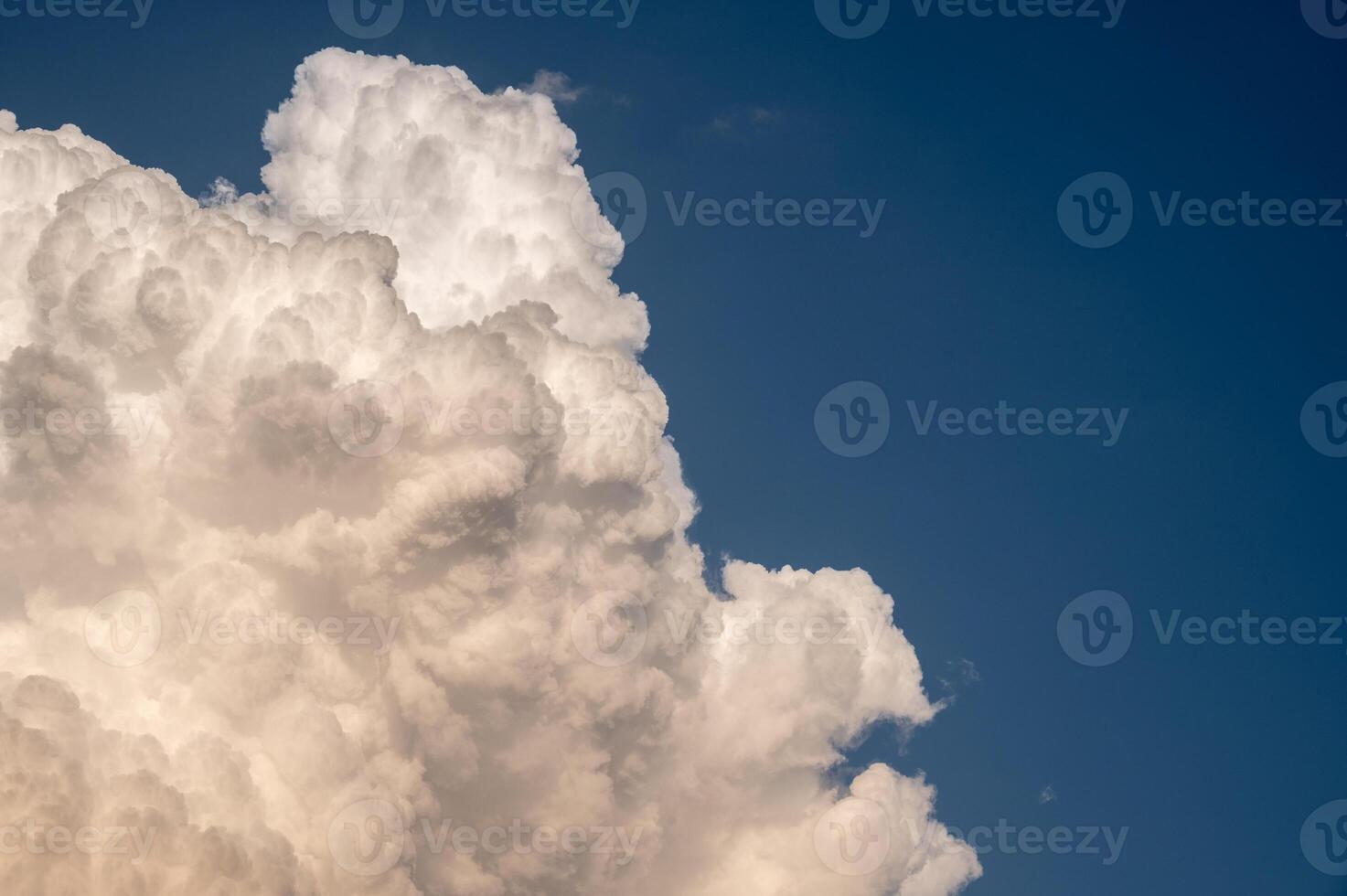 Cumulonimbus clouds appear on the clear sky. photo
