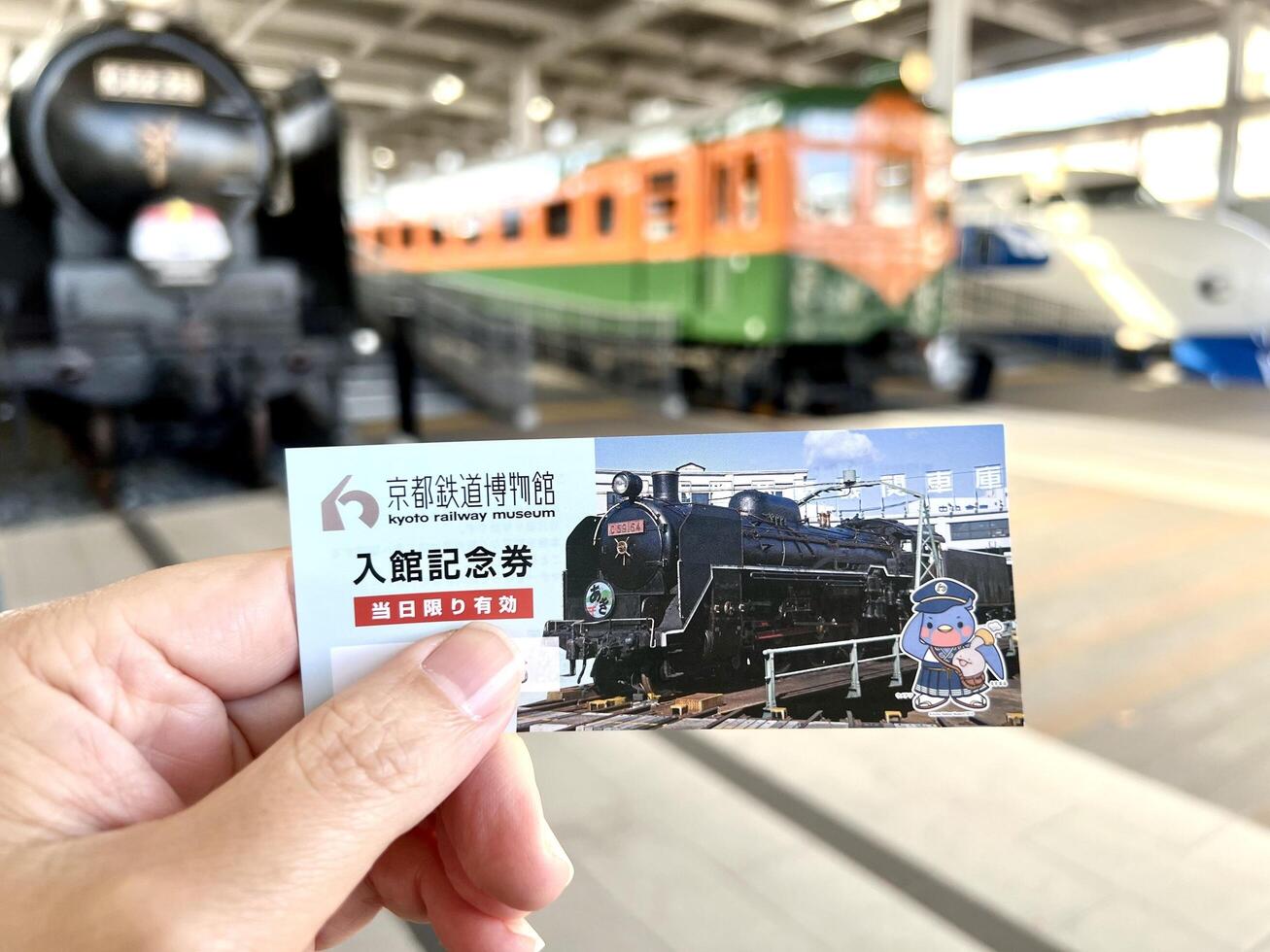 Kyoto city, JP 2024 - Closeup hand of human holding and show Kyoto Railway museum ticket photo
