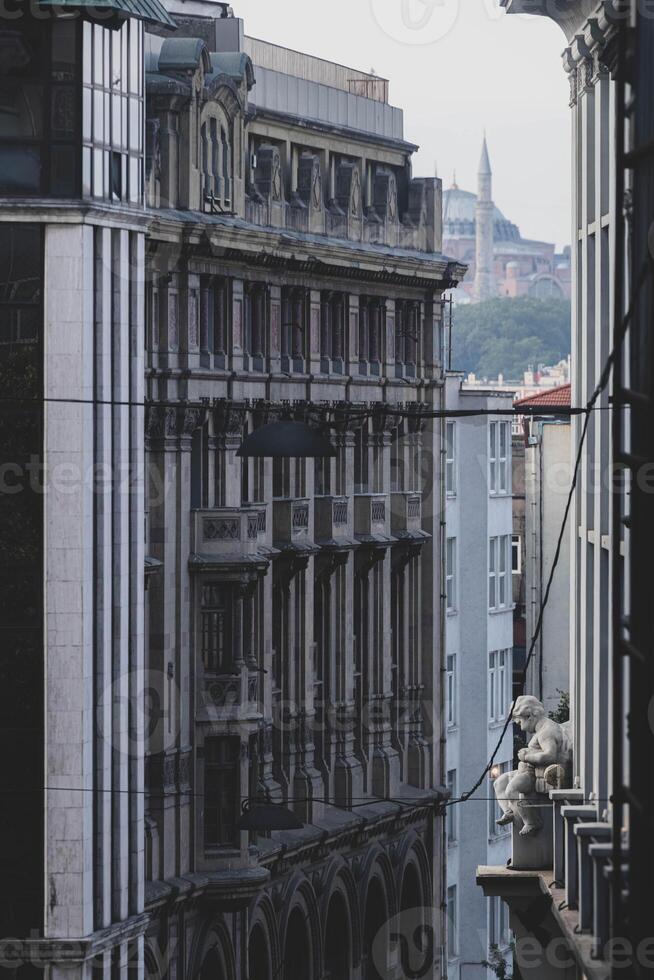 Historic cityscape with classical sculpture and ornate architectural facade photo