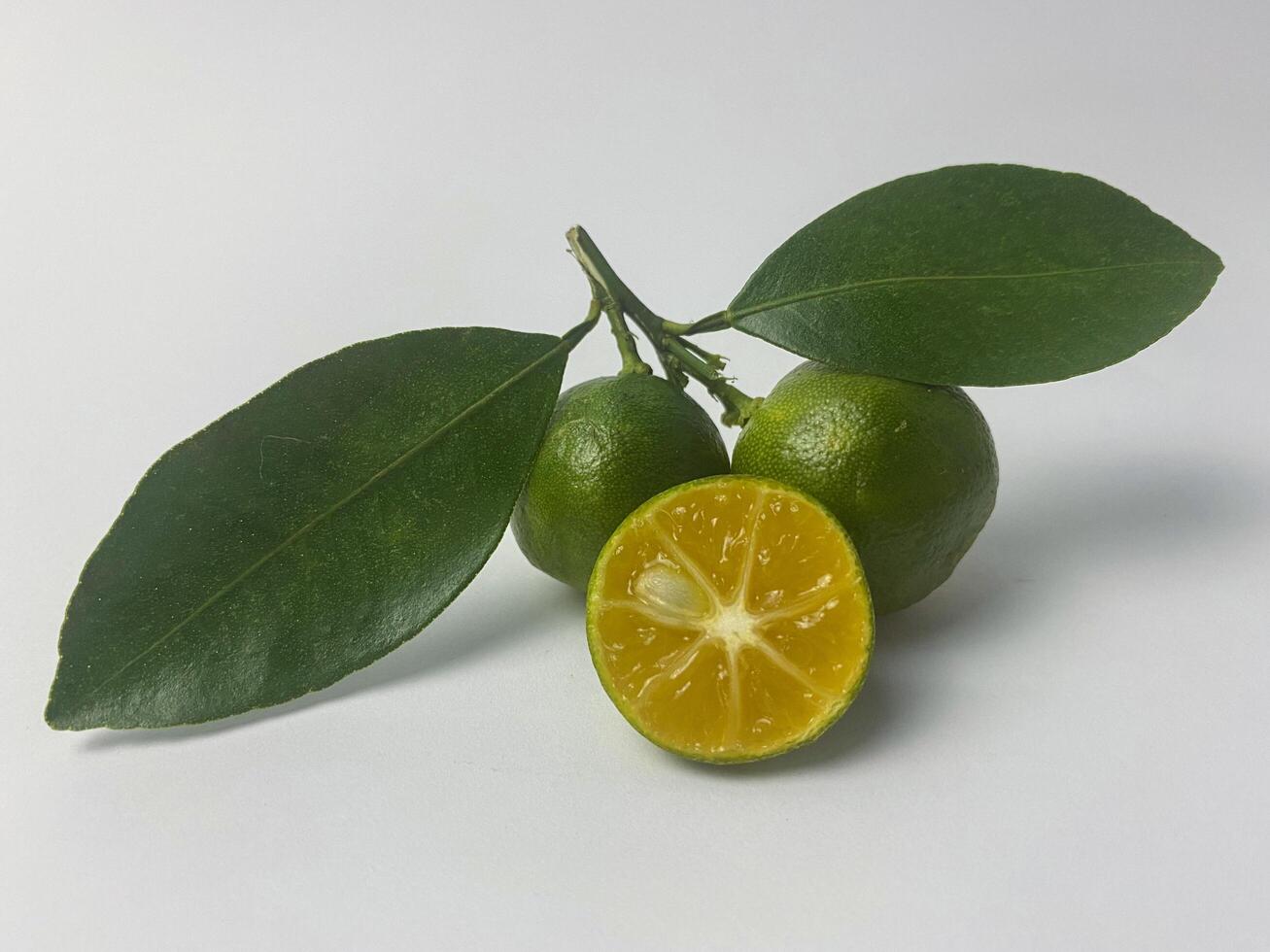 Fresh calamansi fruits with leaves, showcasing vibrant colors and natural beauty photo