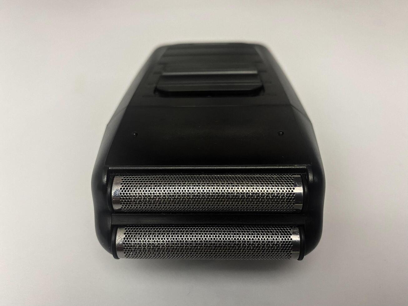 Close-up of a modern electric shaver with a sleek design and dual foil heads photo
