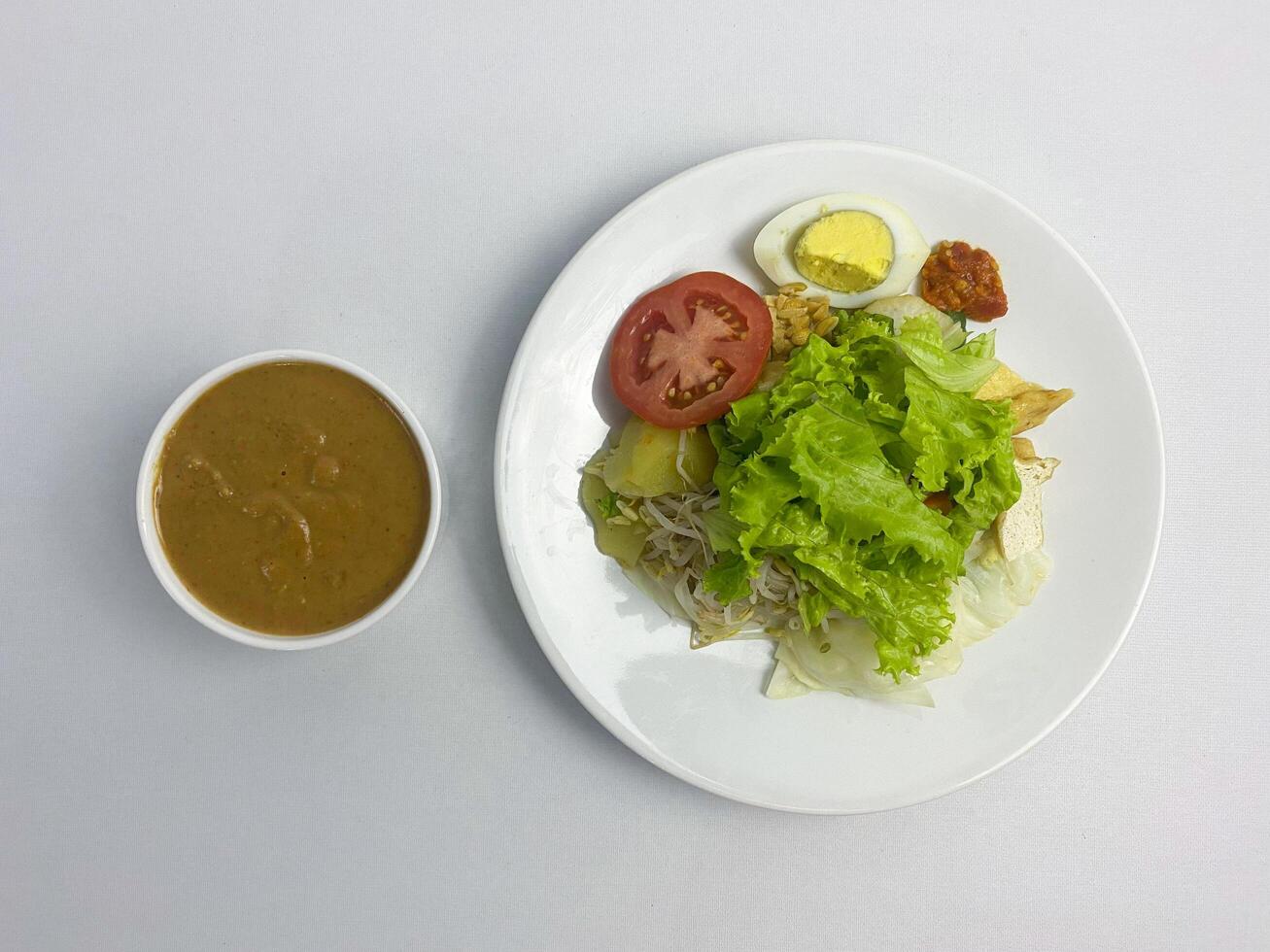 Gado-gado, Indonesian Salad with Peanut Sauce on White Background, overhead shot photo