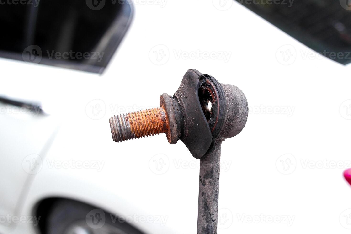 Stabilizer bar link worn out or stabilizer ball joint degraded, A close-up of a rusty, worn anti-roll bar link photo
