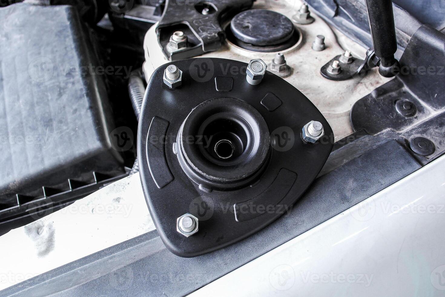 Upper strut mount or suspension strut mount, strut component on engine bay. photo