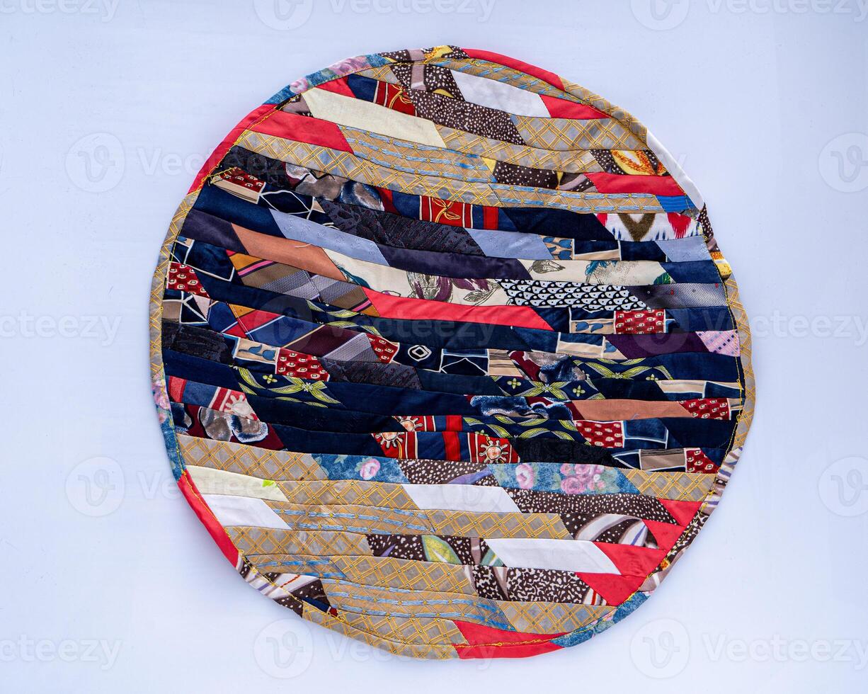 Patchwork. A fragment of multi-colored pieces of fabric sewn together. Round rug photo