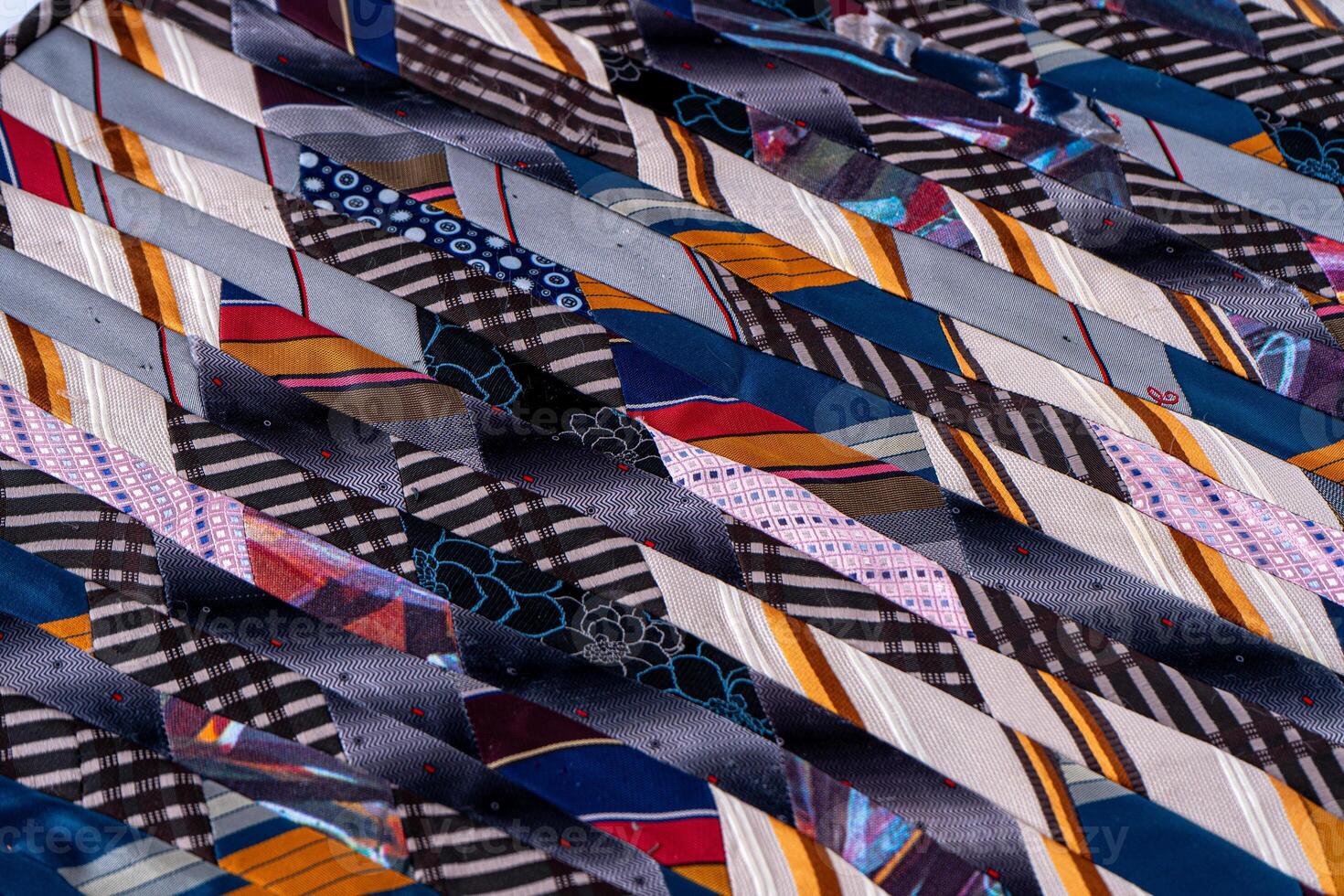 Patchwork. A fragment of multi-colored pieces of fabric sewn together. Colorful Quilted Patchwork Fabric Blanket photo