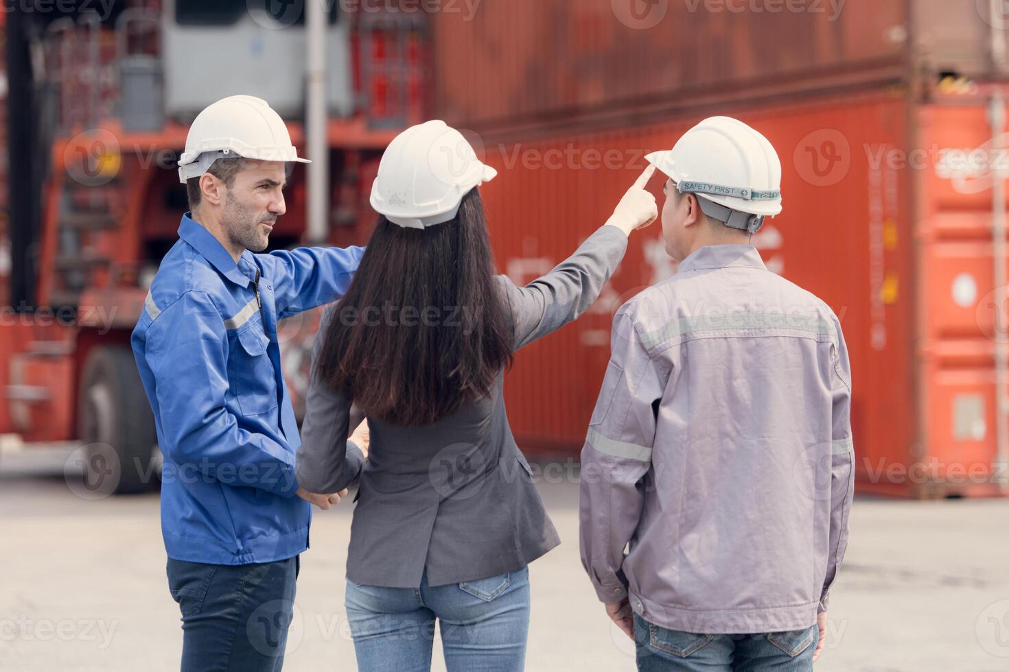 Container manufacturing manager and businesswomen survey the area to plan the storage and moving of goods in and out of the container storage area,160 photo