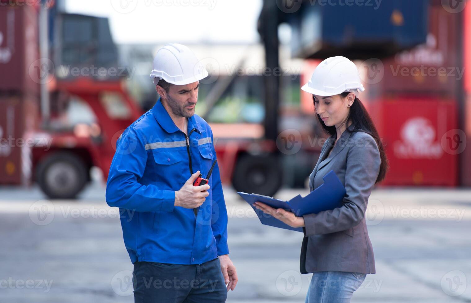 Container manufacturing manager and businesswomen survey the area to plan the storage and moving of goods in and out of the container storage area,148 photo