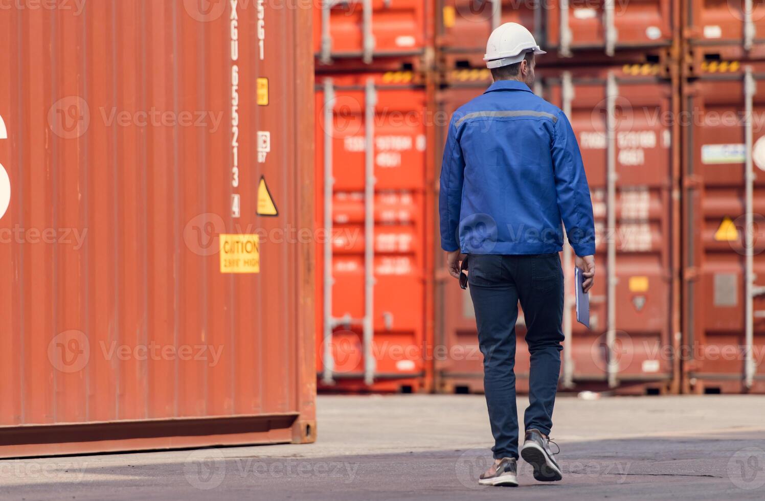 Portrait of a worker in a container warehouse survey the area to plan the storage and moving of goods in and out of the container storage area,151 photo