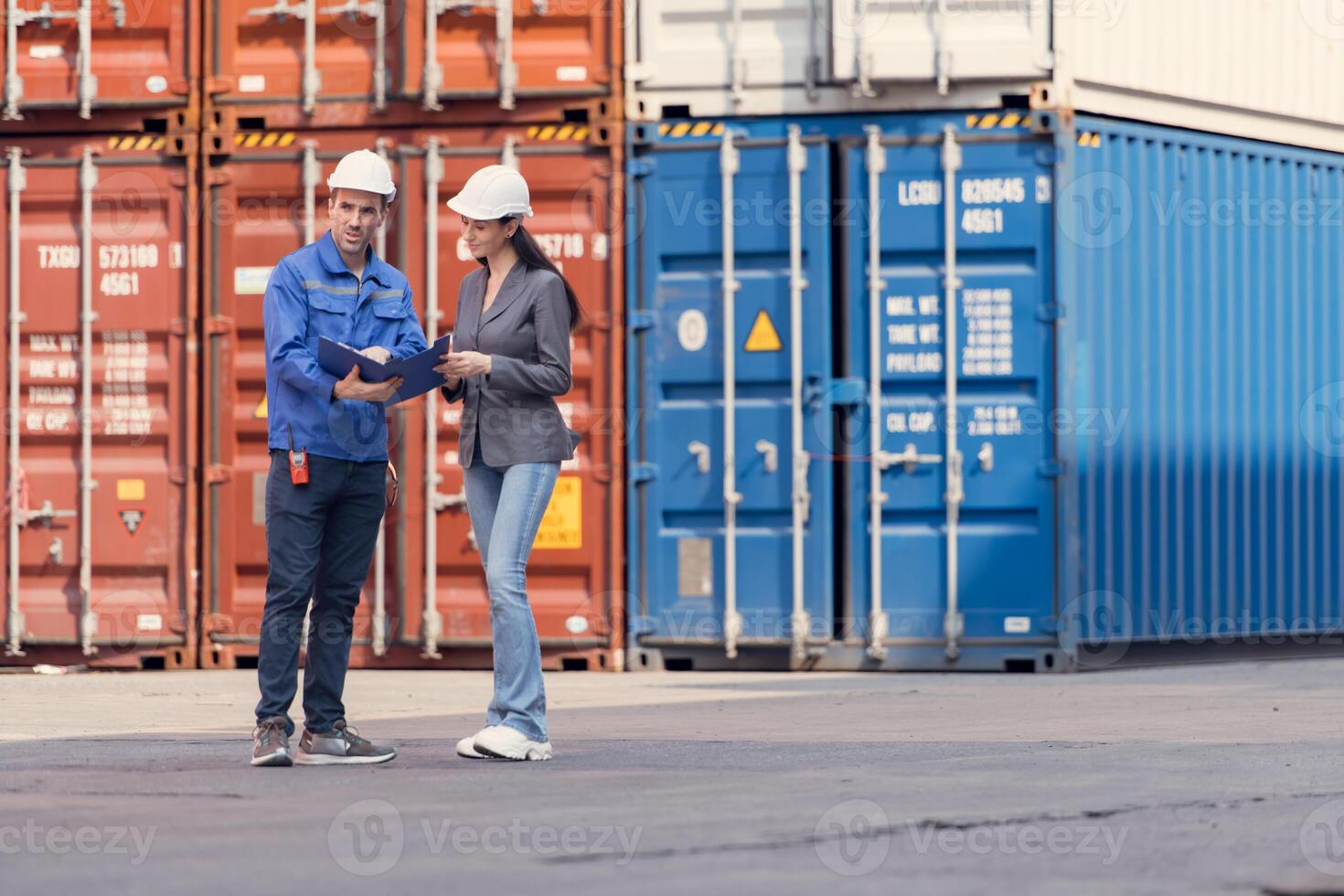 Container manufacturing manager and businesswomen survey the area to plan the storage and moving of goods in and out of the container storage area,145 photo