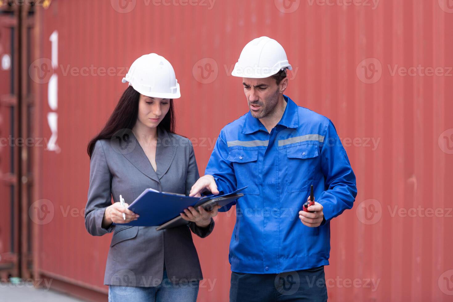 Container manufacturing manager and businesswomen survey the area to plan the storage and moving of goods in and out of the container storage area,139 photo