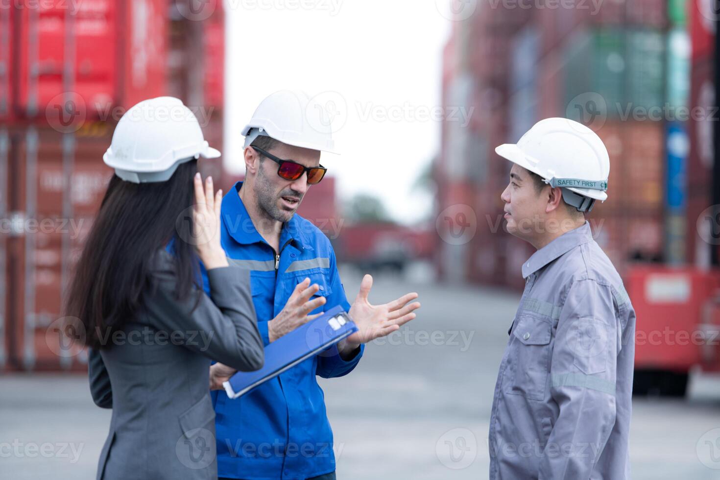 Container manufacturing manager and businesswomen survey the area to plan the storage and moving of goods in and out of the container storage area,140 photo