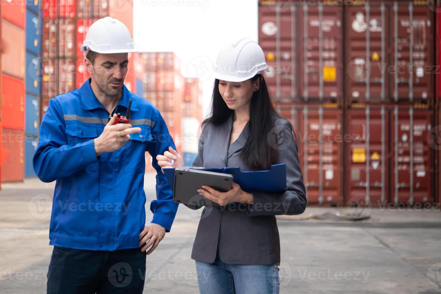 Container manufacturing manager and businesswomen survey the area to plan the storage and moving of goods in and out of the container storage area,137 photo