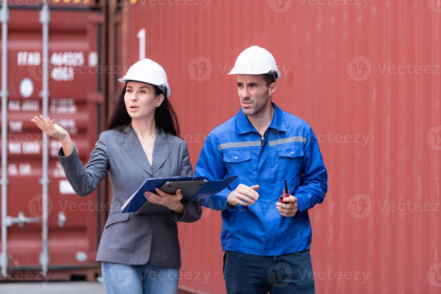 Container manufacturing manager and businesswomen survey the area to plan the storage and moving of goods in and out of the container storage area,134 photo