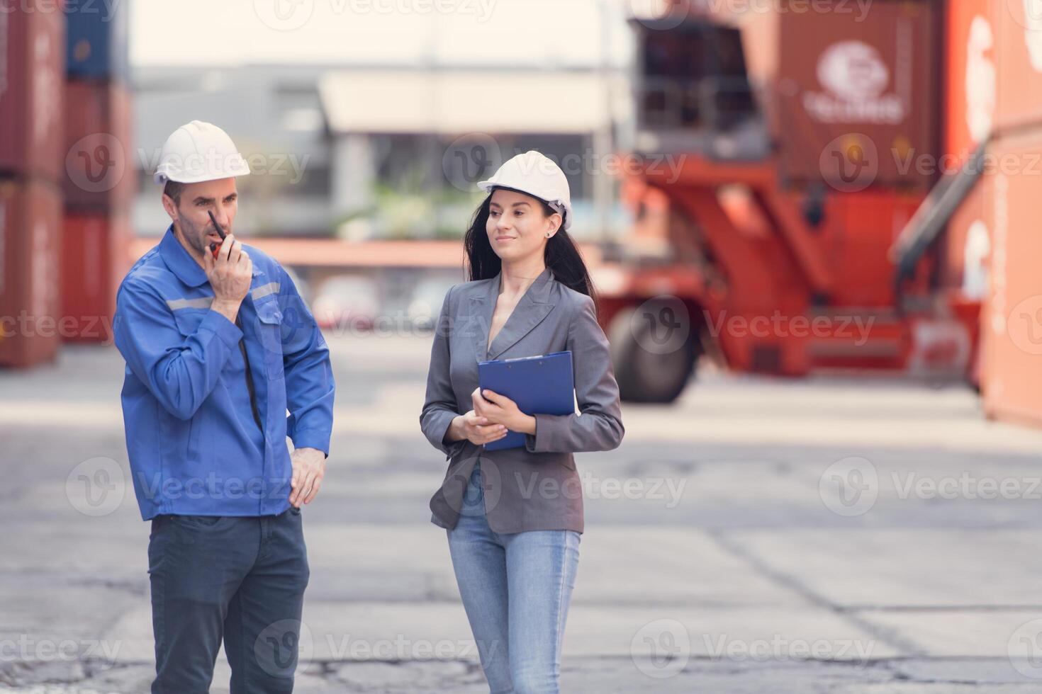 Container manufacturing manager and businesswomen survey the area to plan the storage and moving of goods in and out of the container storage area,132 photo