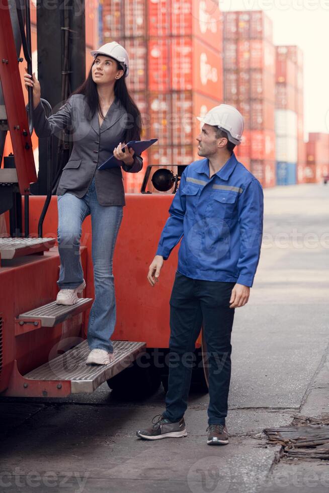 Container manufacturing manager and businesswomen survey the area to plan the storage and moving of goods in and out of the container storage area,131 photo