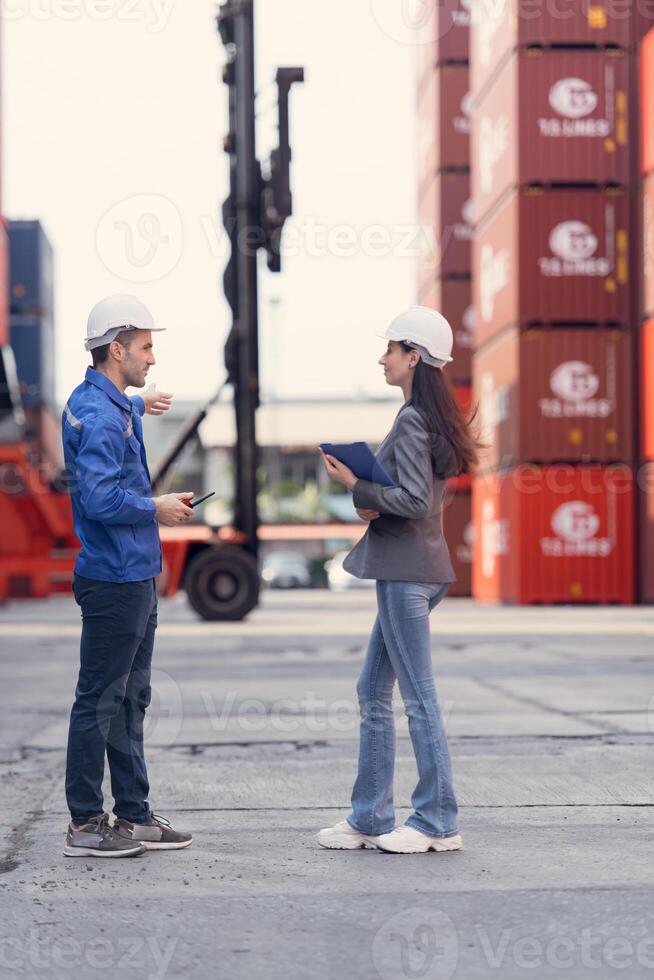 Container manufacturing manager and businesswomen survey the area to plan the storage and moving of goods in and out of the container storage area123 photo