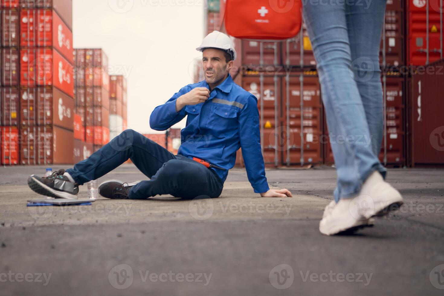 First aid for a container warehouse worker fainted while working in the bright sunlight and hot weather of a container storage yard,118 photo