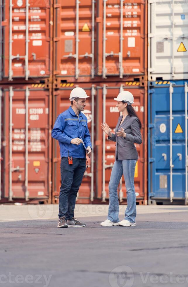 Container manufacturing manager and businesswomen survey the area to plan the storage and moving of goods in and out of the container storage area,117 photo