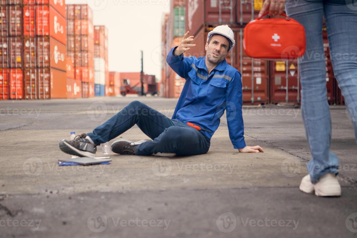 First aid for a container warehouse worker fainted while working in the bright sunlight and hot weather of a container storage yard,116 photo