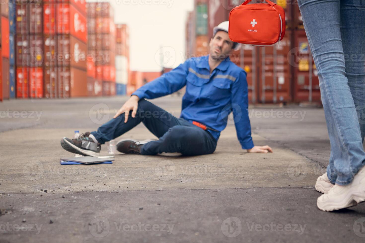 First aid for a container warehouse worker fainted while working in the bright sunlight and hot weather of a container storage yard,112 photo