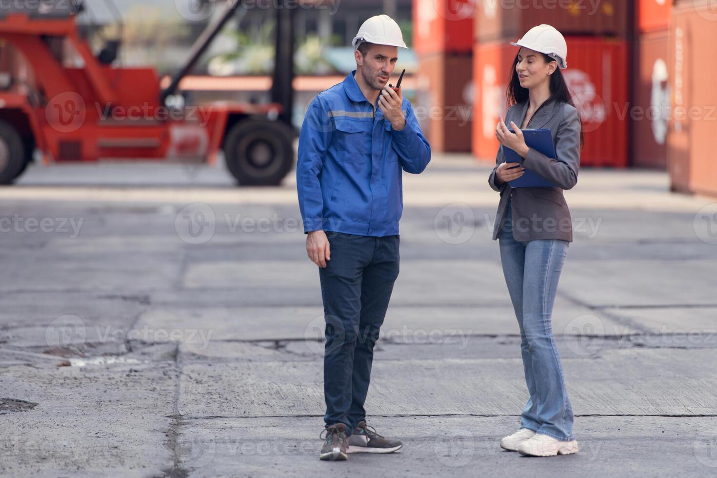 Container manufacturing manager and businesswomen survey the area to plan the storage and moving of goods in and out of the container storage area,109 photo