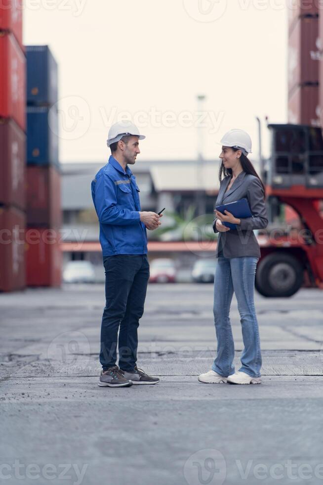 Container manufacturing manager and businesswomen survey the area to plan the storage and moving of goods in and out of the container storage area,108 photo