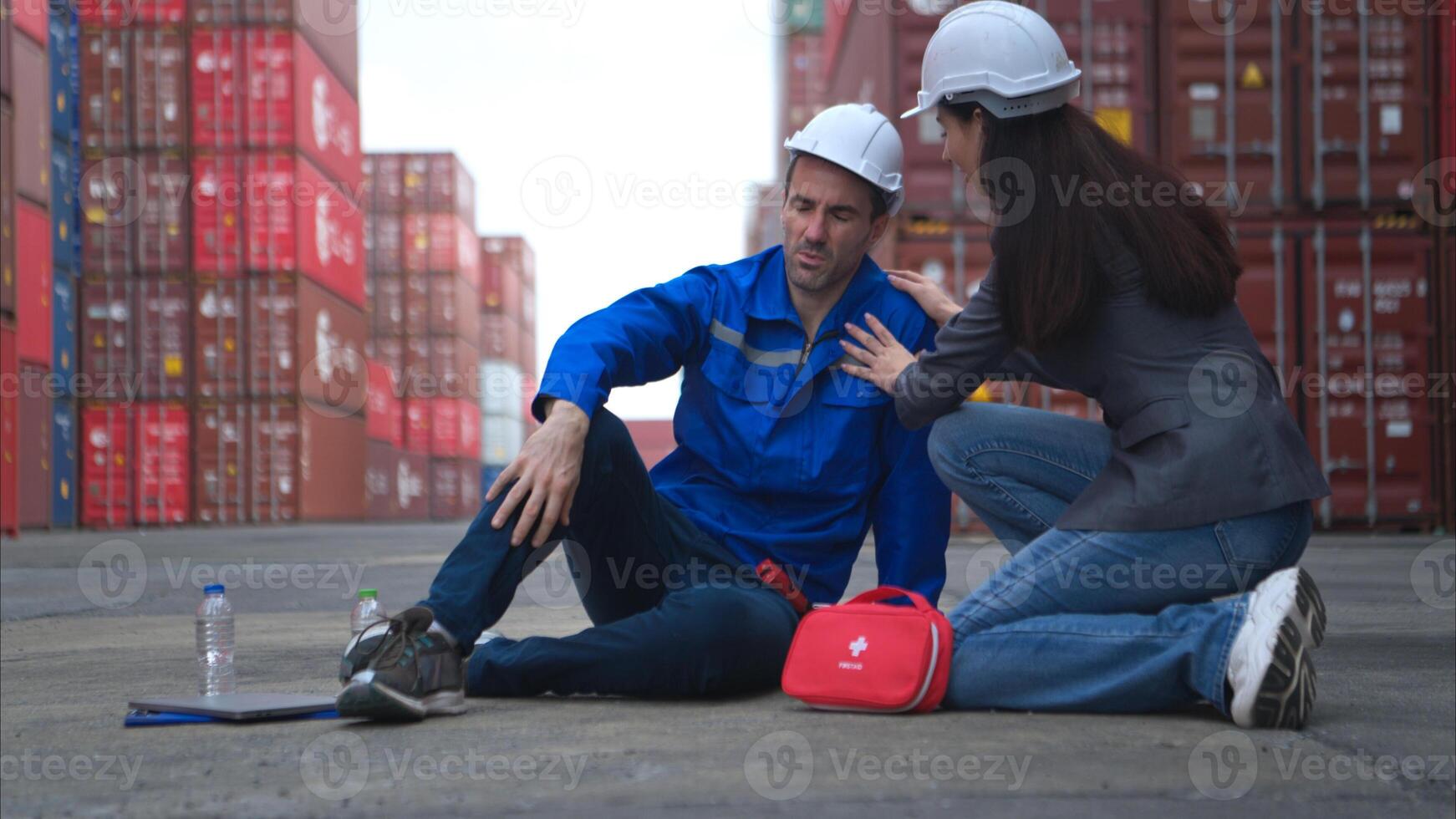 First aid for a container warehouse worker fainted while working in the bright sunlight photo