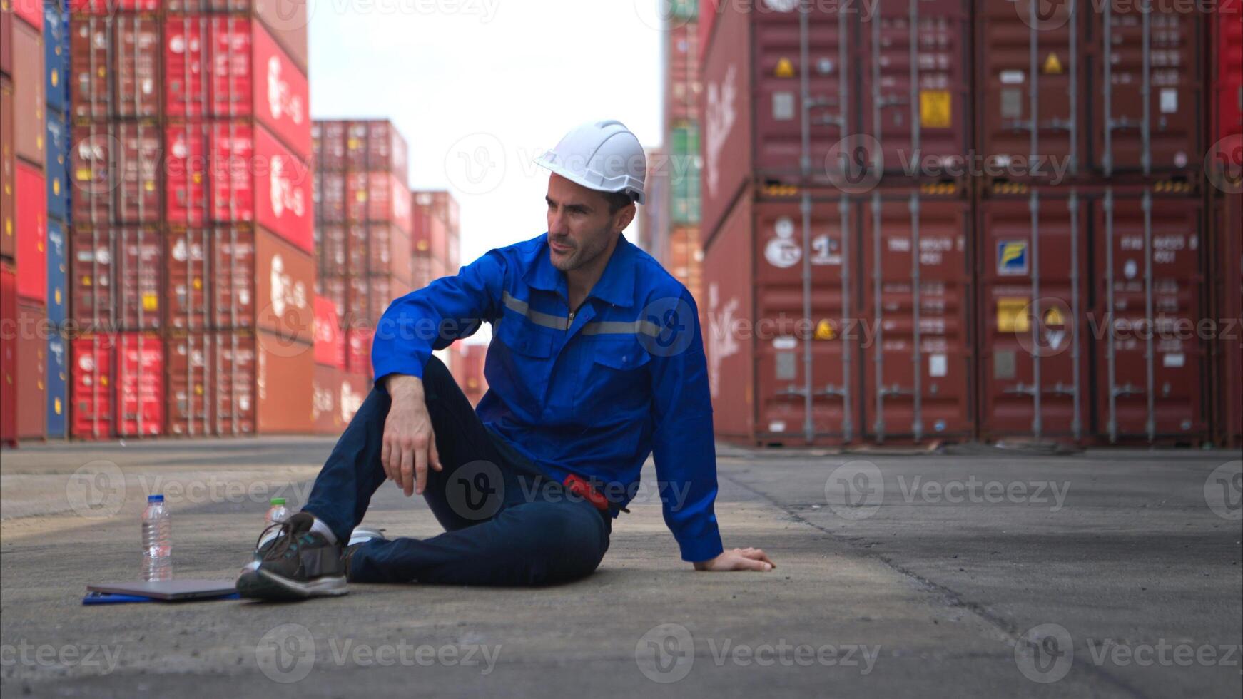 A worker in a container warehouse fainted while working in the bright sunlight photo