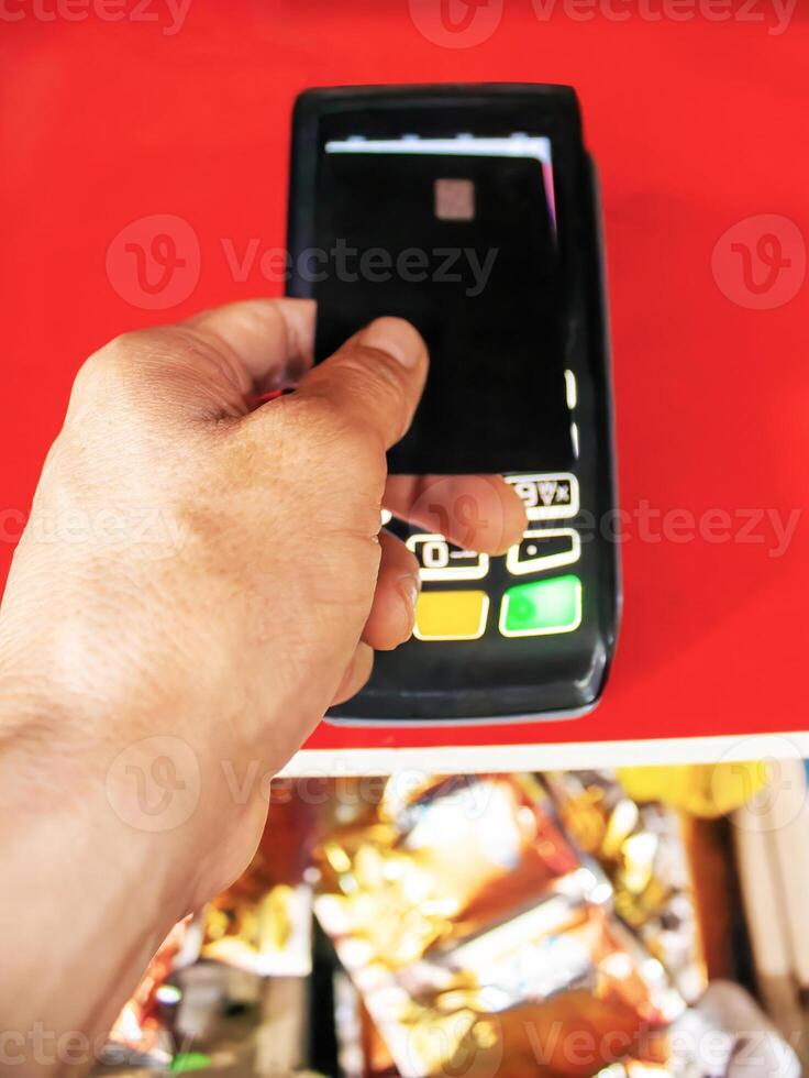 A man pays in a store with a bank card photo