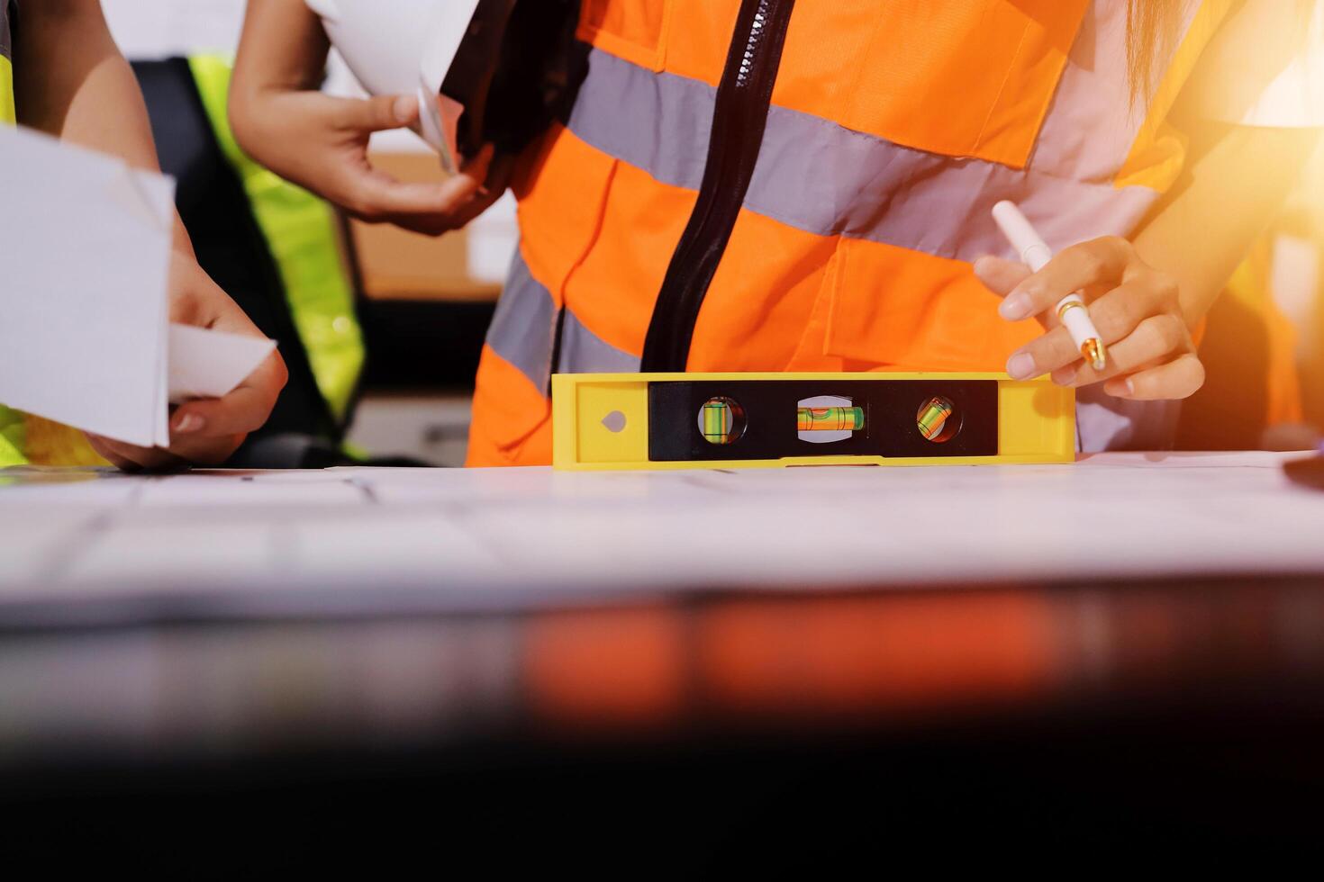 A construction worker is holding a measuring tape photo