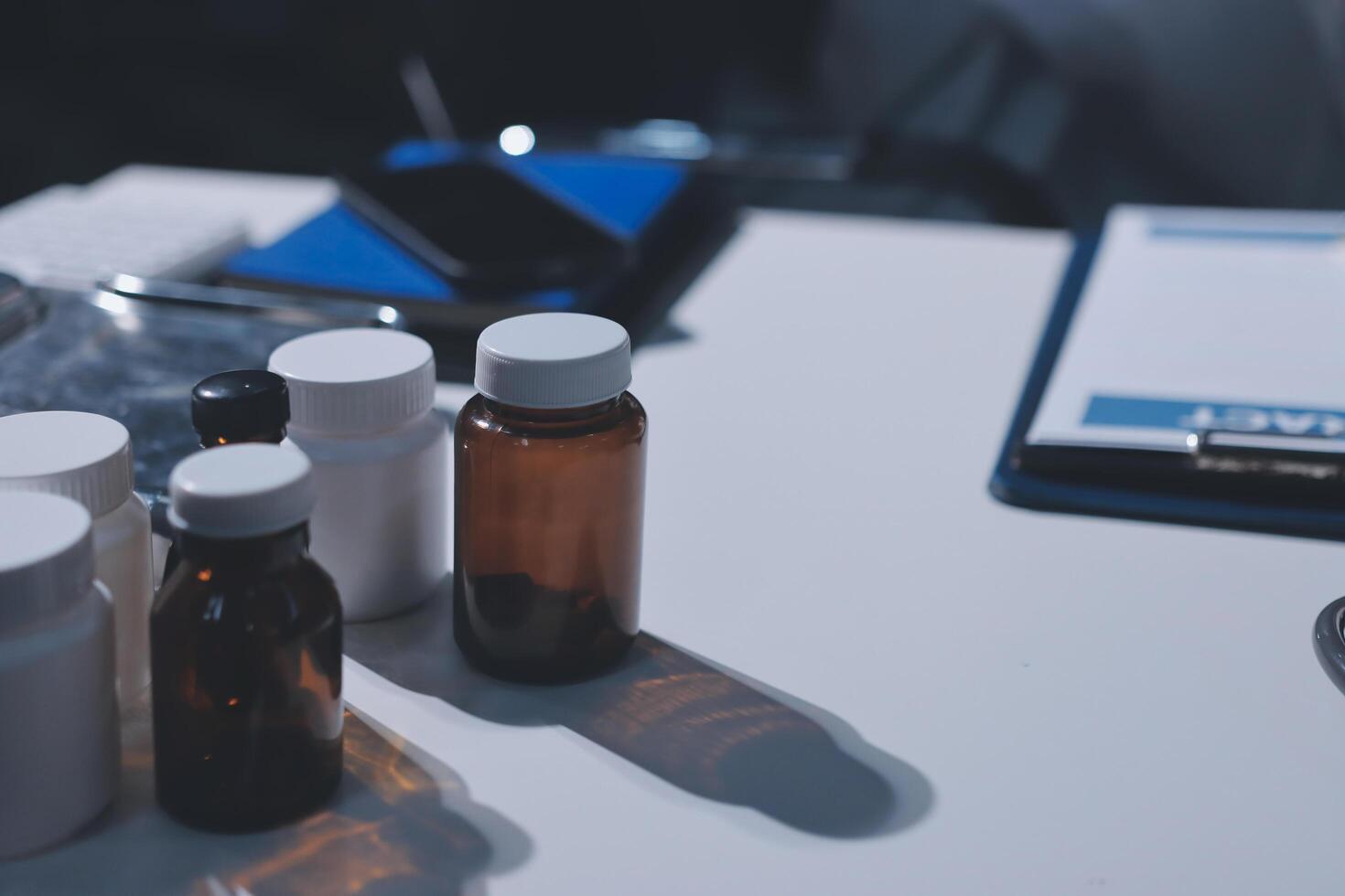 A table with several bottles and a pen on it photo